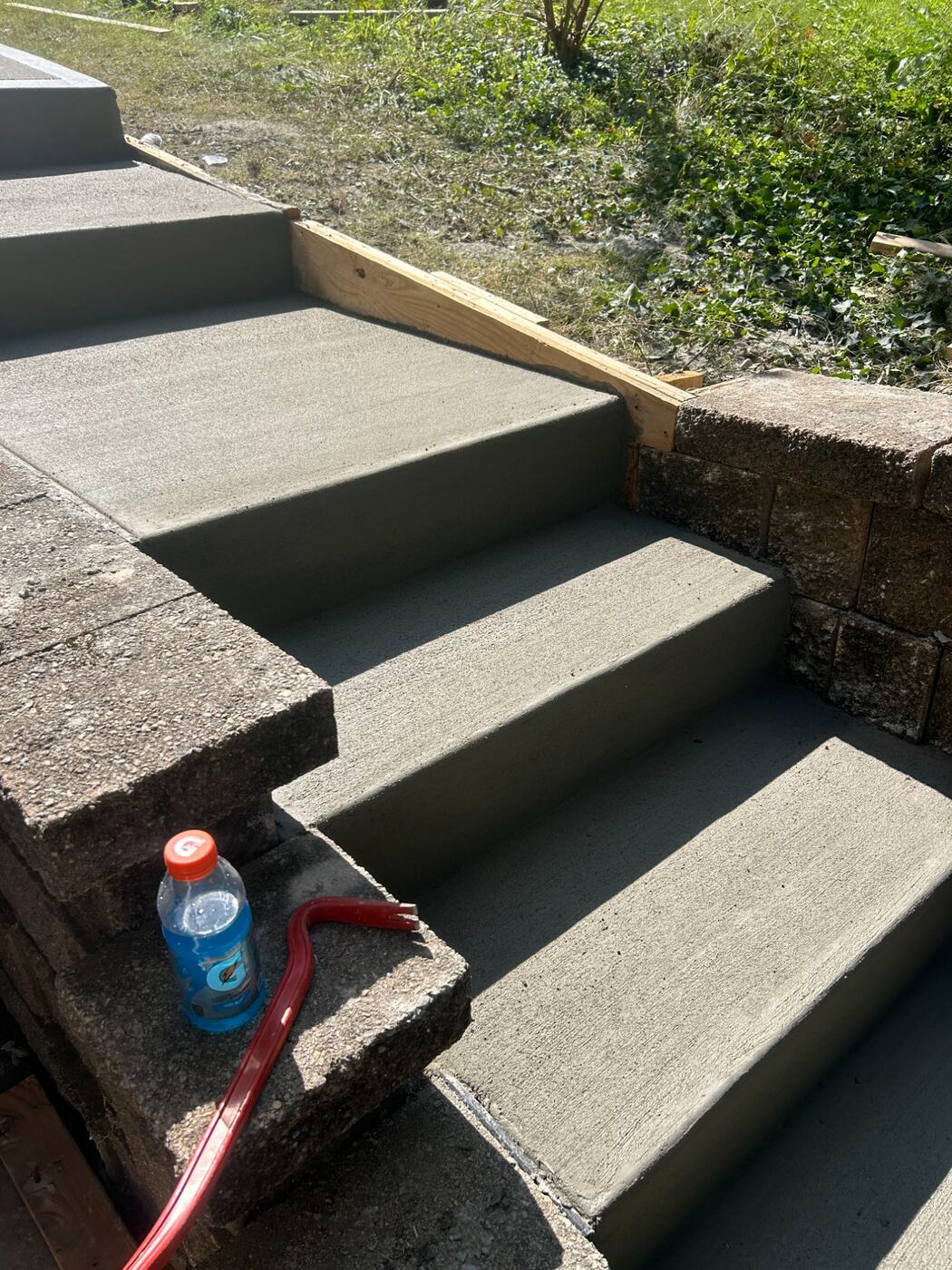New concrete front steps poured between existing block walls